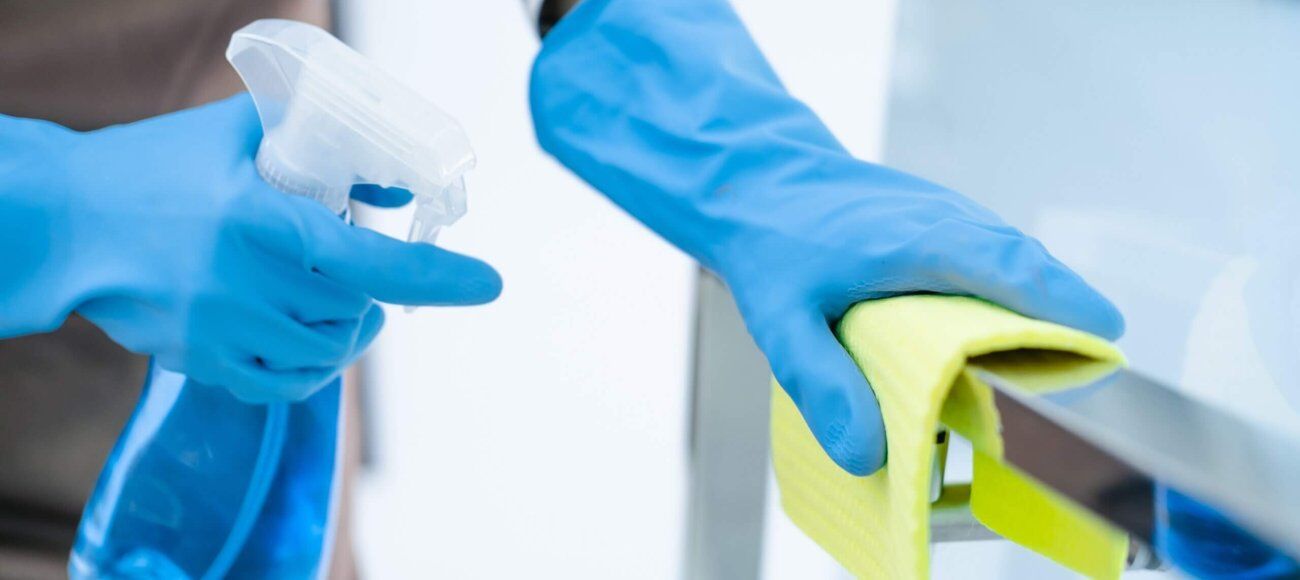 Person Cleaning with a disinfectant